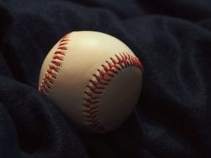 A baseball on a blue cloth; image by Anastasia Zhenina, via Pexels, CC0.
