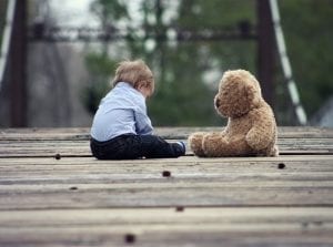 Image of a baby boy and his teddy
