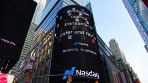 Blockchain billboard in Times Square, New York City, saying &ldquo;Blockchain making transactions safer and faster. Nasdaq.&rdquo; Image by Pascal Bernardon, via Unsplash.com.