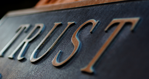 Plaque saying &ldquo;Trust.&rdquo; Image by Terry Johnston from Grand Rapids, USA / CC BY (https://creativecommons.org/licenses/by/2.0), via Wikimedia Commons, no changes.