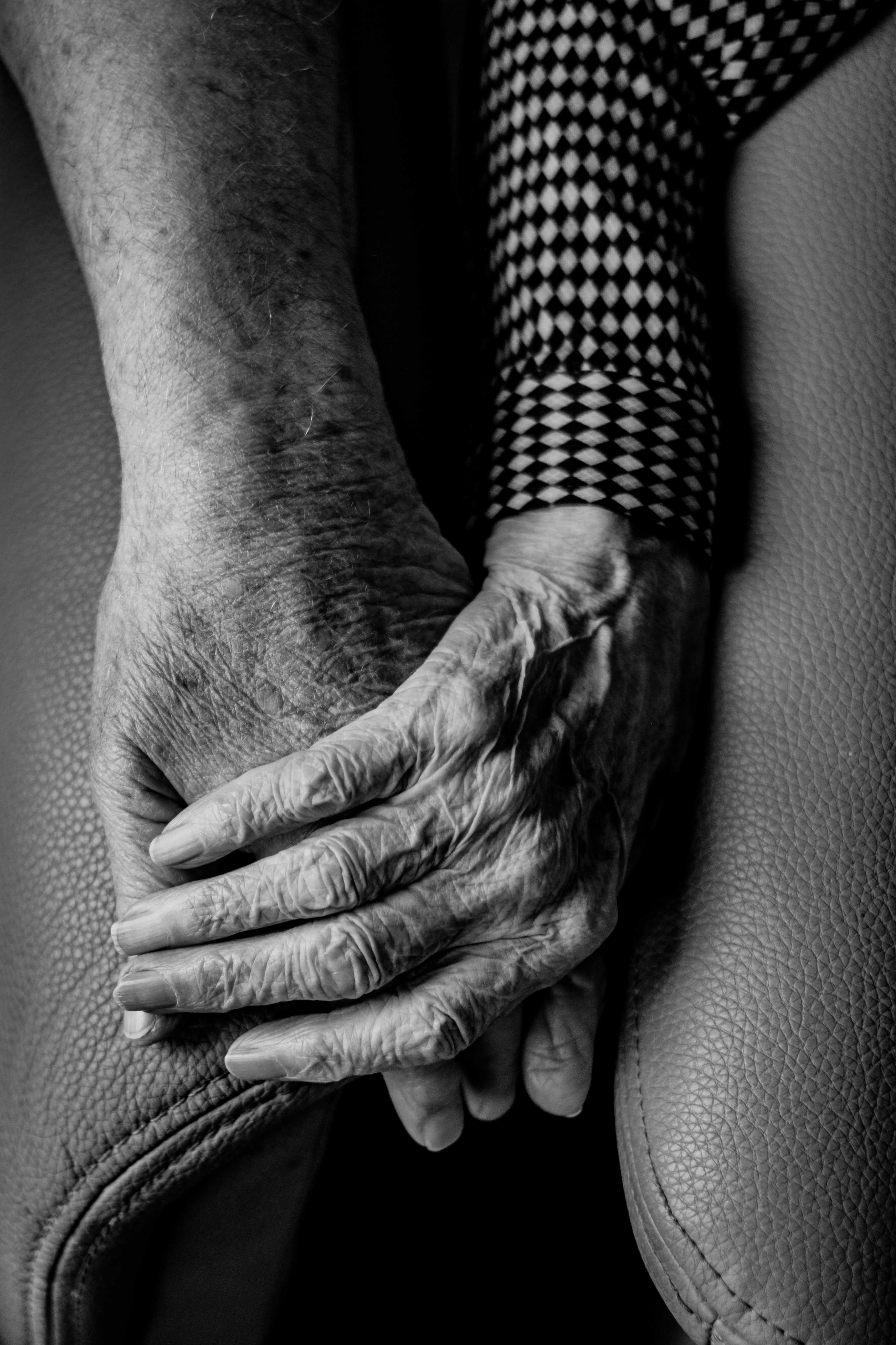 Elderly couple holding hands; image by Gert Stockmans, via Unsplash.com.