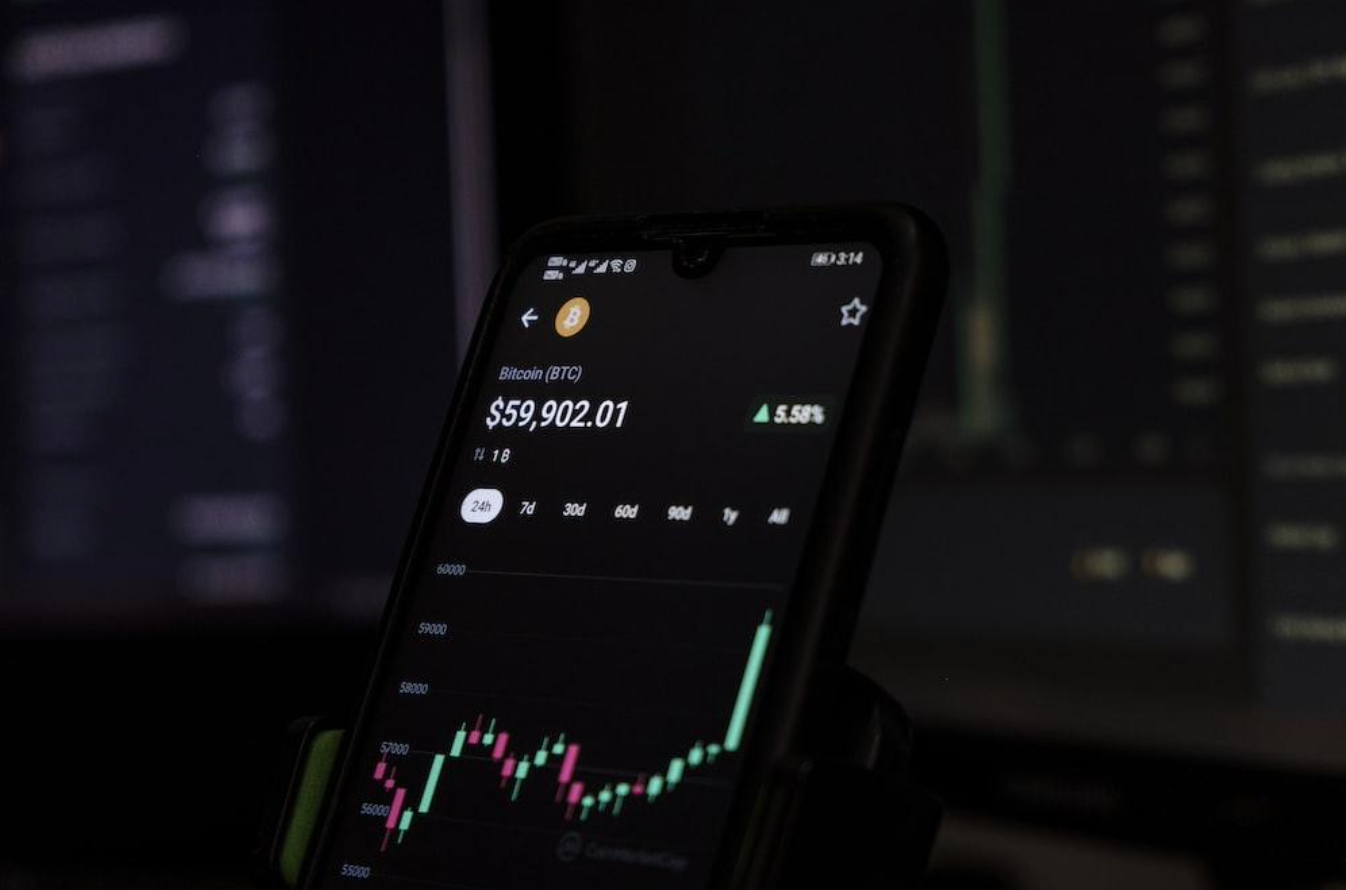 Smart device showing Bitcoin account growth; image by Sajad Nori, via Unsplash.com.