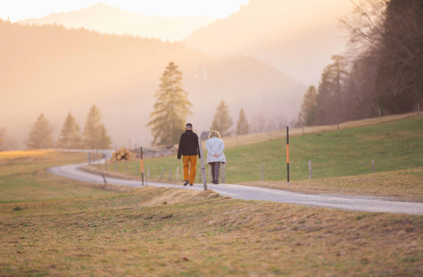 Older couple walking path; image by Wedding Dreamz, via Unsplash.com.