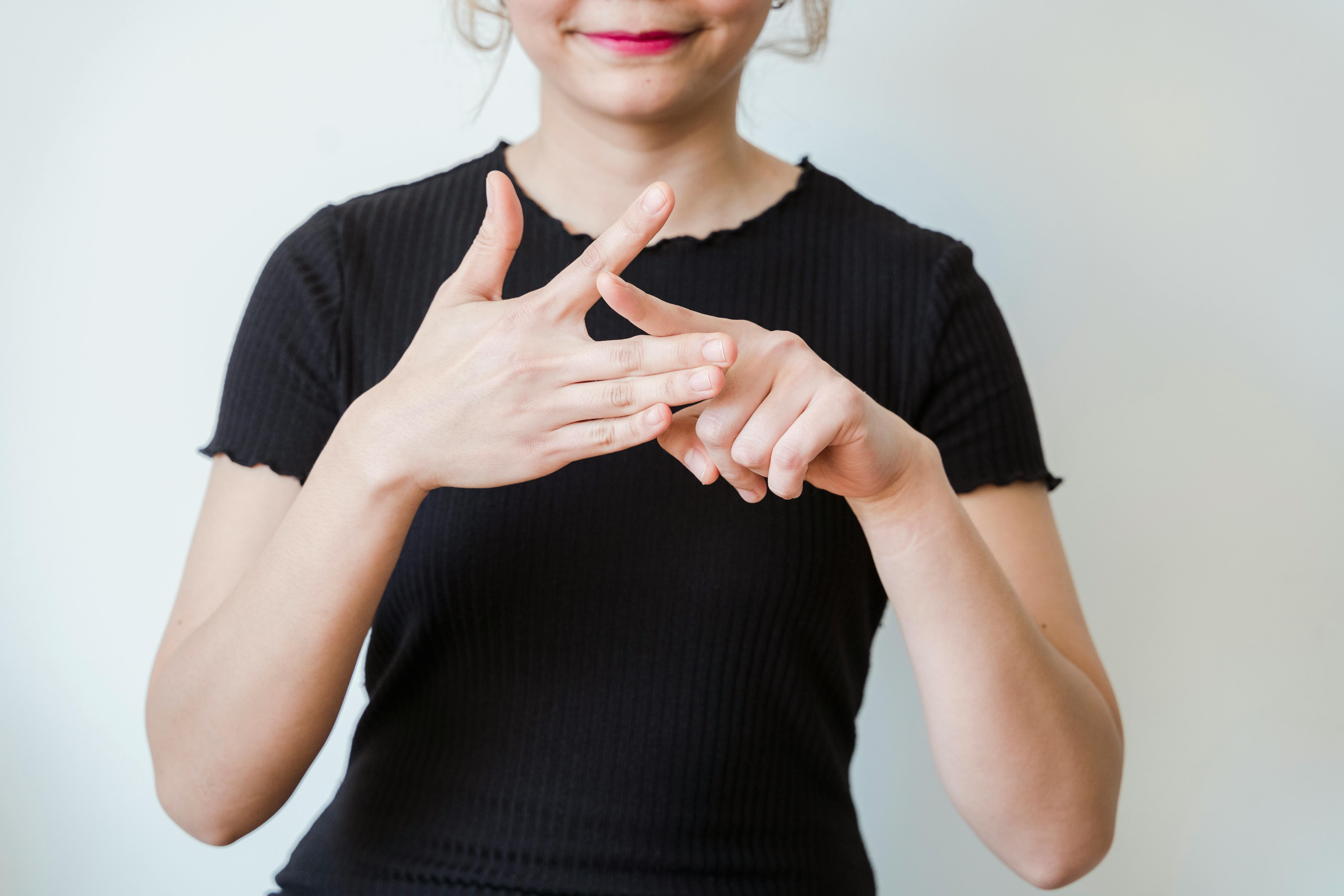 Woman speaking ASL; image by Kevin Malik, via Pexels.com.