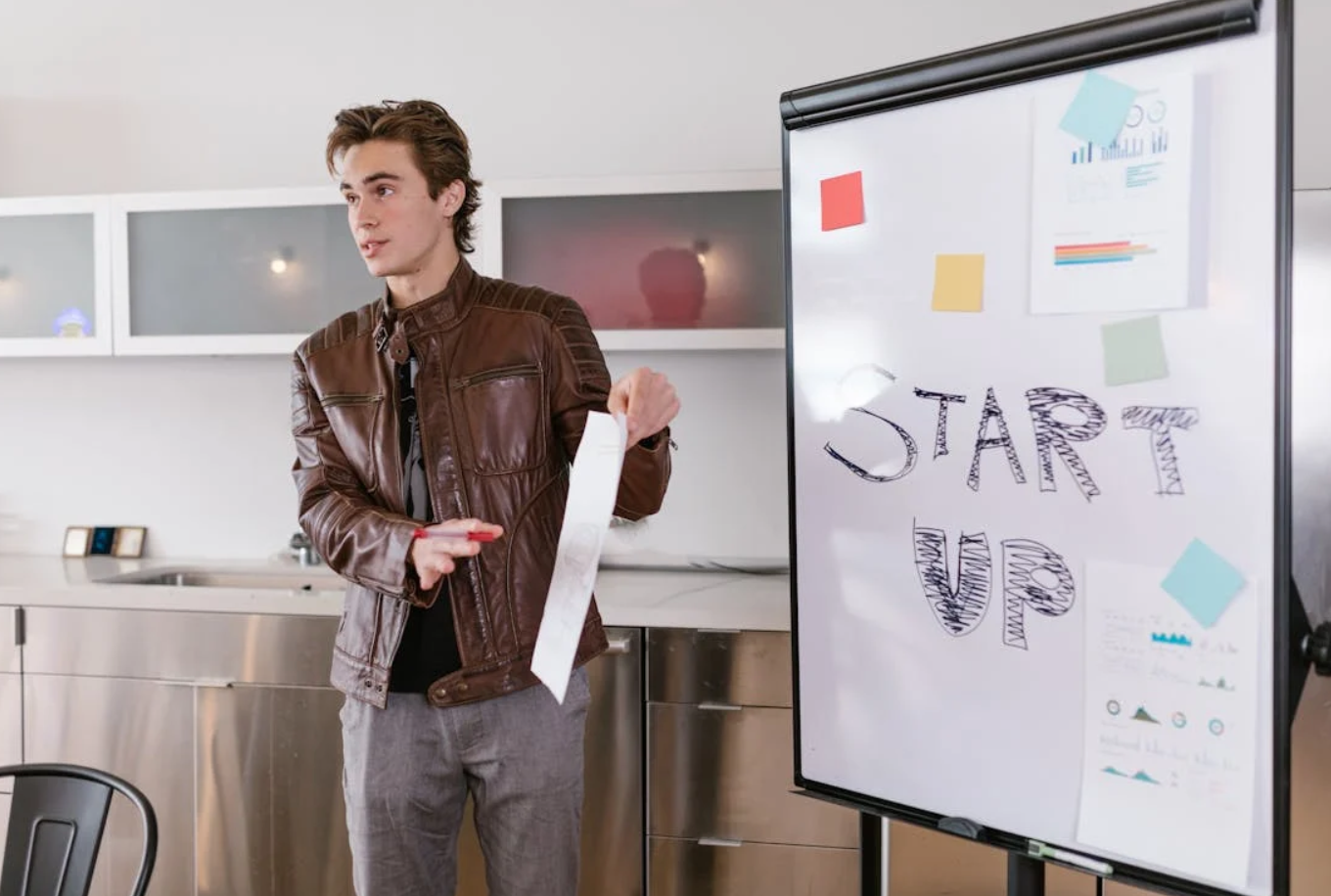 Young man making business pitch to investor; image by RDNE Stock Project, via Pexels.com.