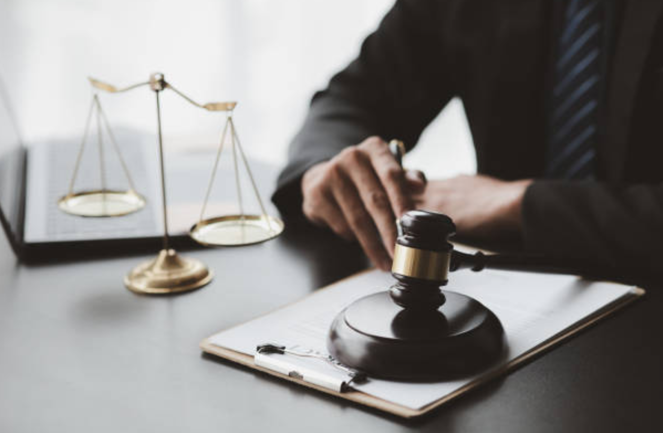 Lawyer working at desk; image by KamiPhotos, via istockphoto.com.