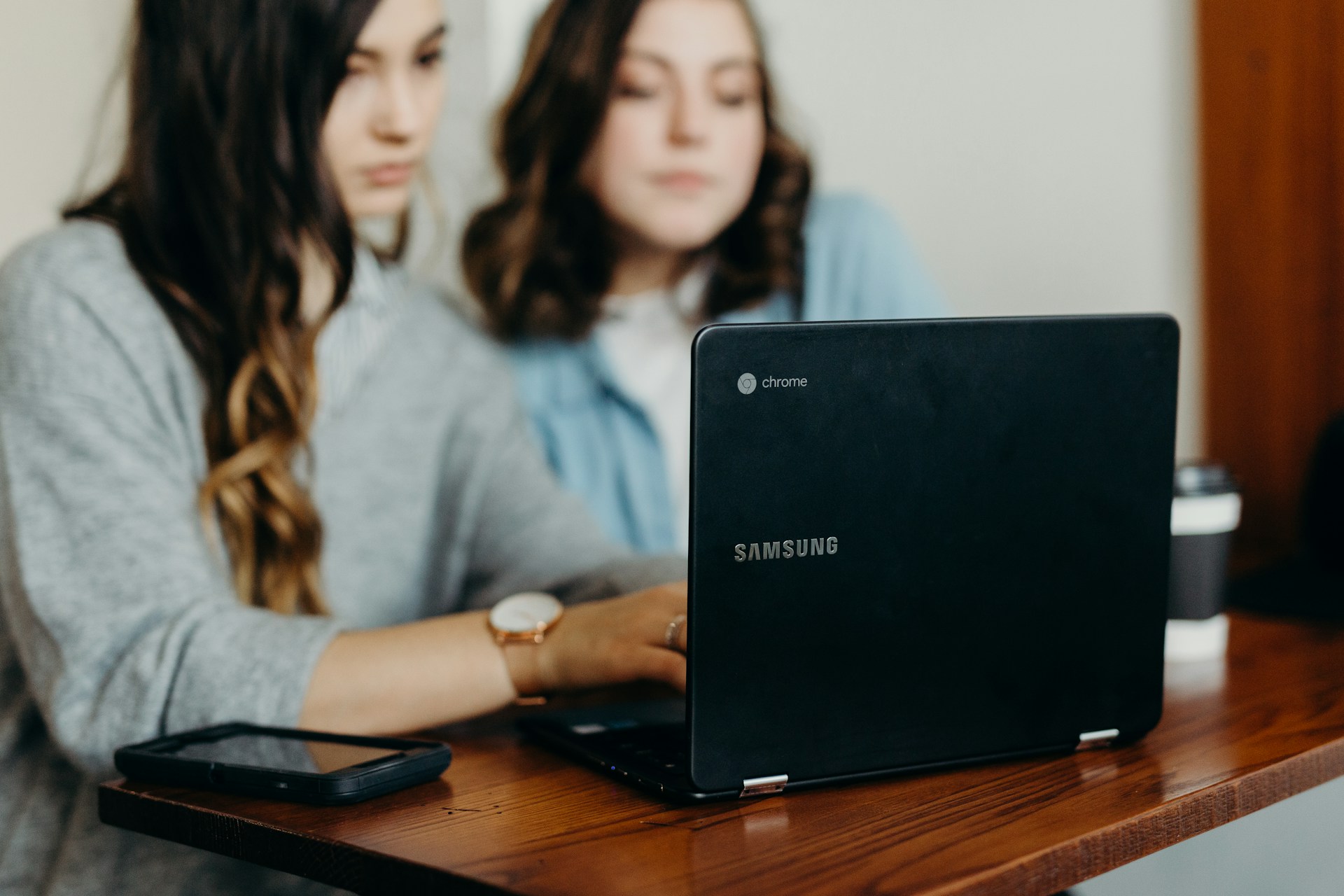 Two woman using laptop; image by Brooke Cagle, via Unsplash.com.