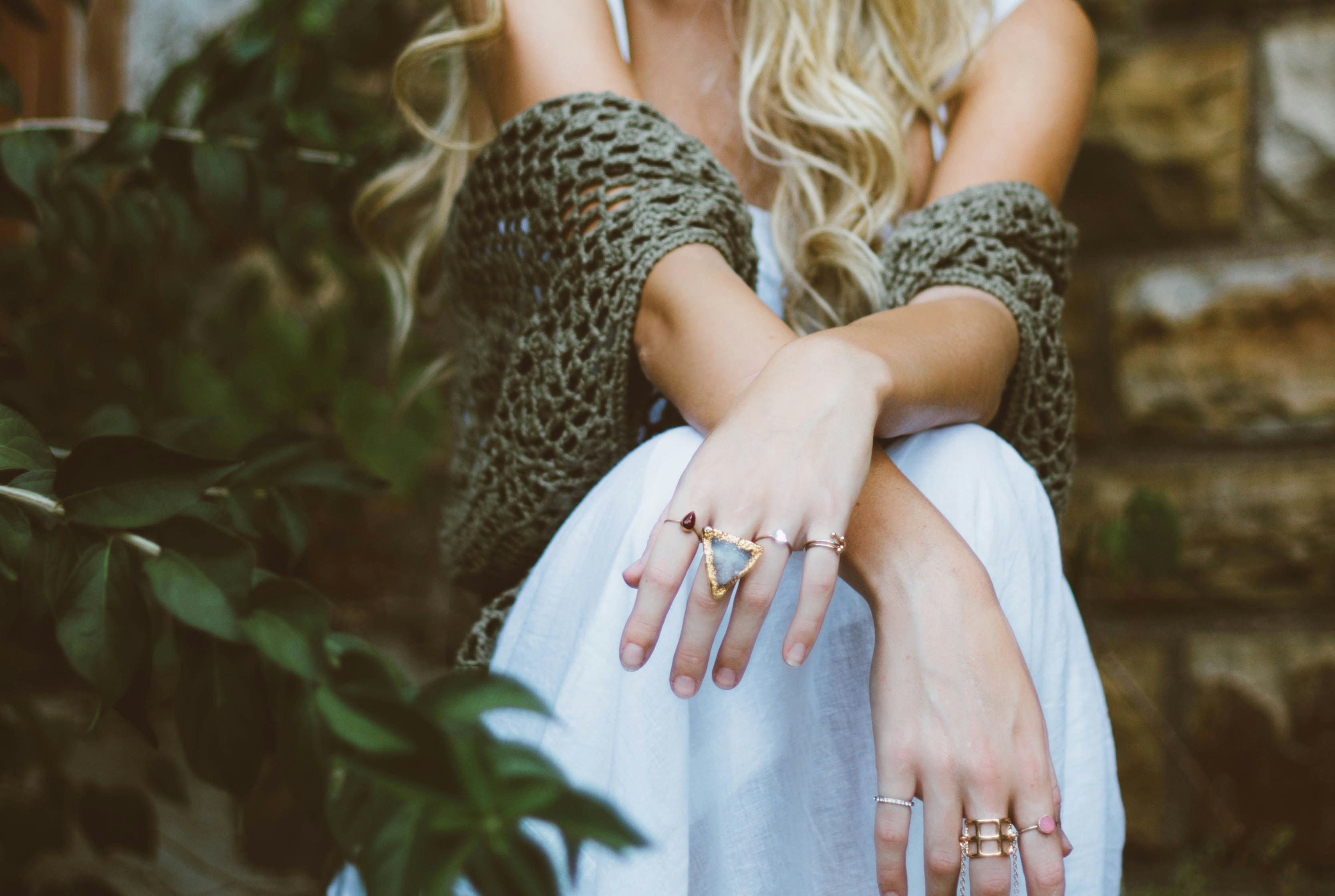 Woman in white dress and green shawl wearing multiple rings; image by Brooke Cagle, via Unsplash.com.